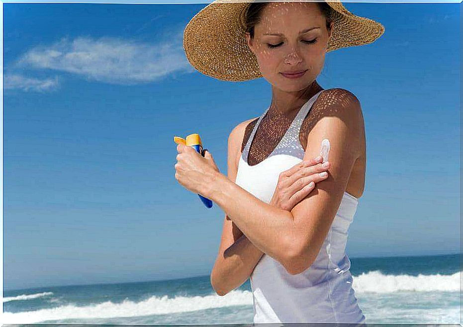 Woman putting on sunscreen