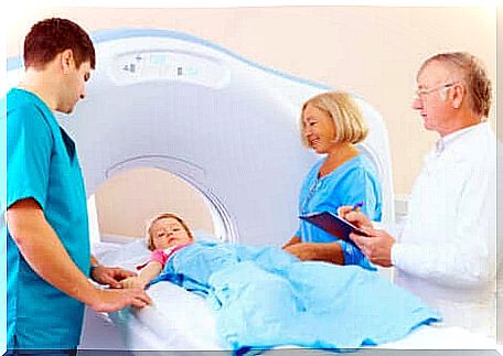 A child with a medical team before a computed tomography scan. 