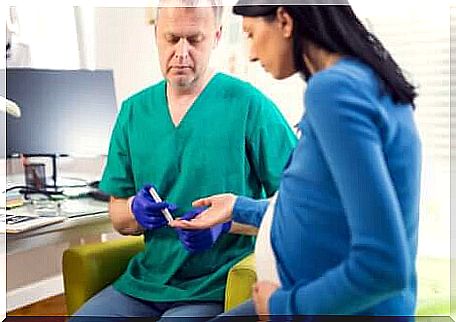 A pregnant woman testing her blood sugar. 