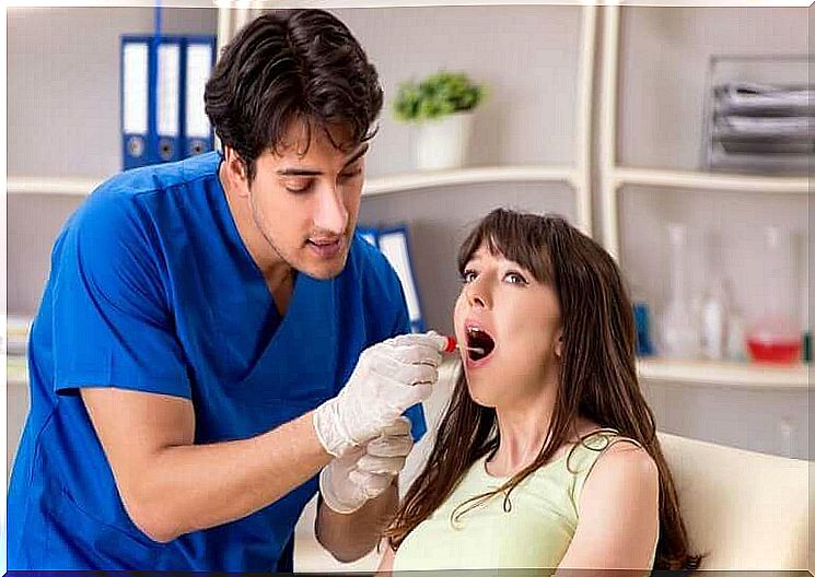 A dentist examining the submandibular glands of a woman